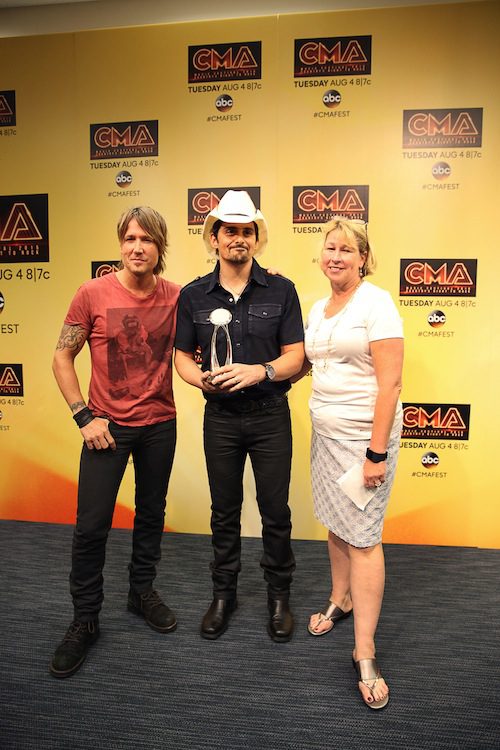 Brad Paisley receives the CMA International Artist Achievement Award backstage at the CMA Music Festival during a press conference at the Nightly Concert Sunday at LP Field. (L-R) Keith Urban, CMA Foundation National Ambassador; Paisley; and Sarah Trahern, CMA Chief Executive Officer. Photo: Hunter Berry / CMA